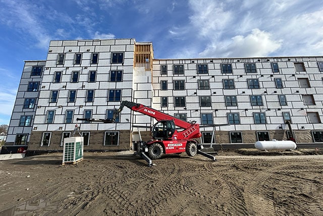 Machinery lifting unit in front of partially complete 45 Dougherty building.