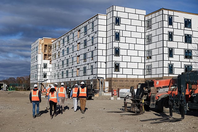 PGC team members walking toward partially complete 45 Dougherty building.